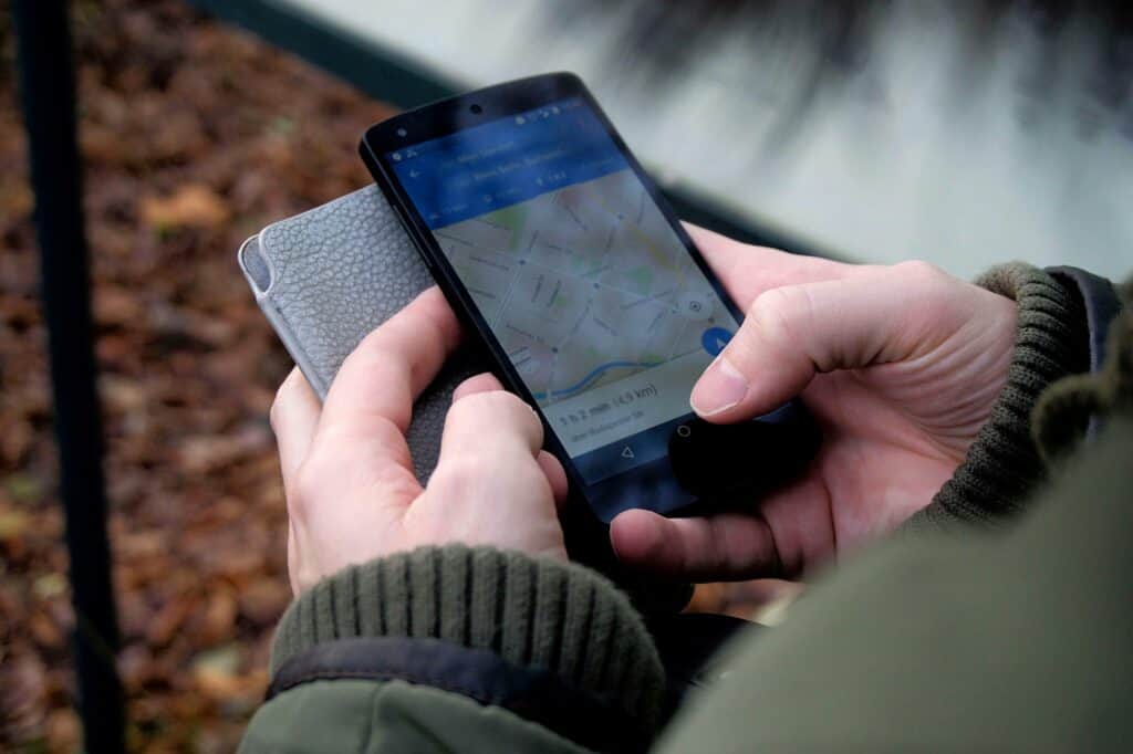 A man is checking Google Maps on his phone