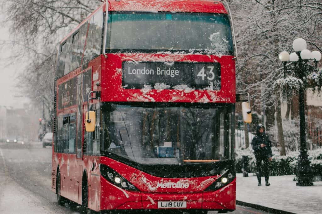 A double-decker to London Bridge while snowing