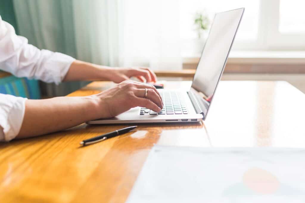 Cropped image of a man's hands researching removal companies online