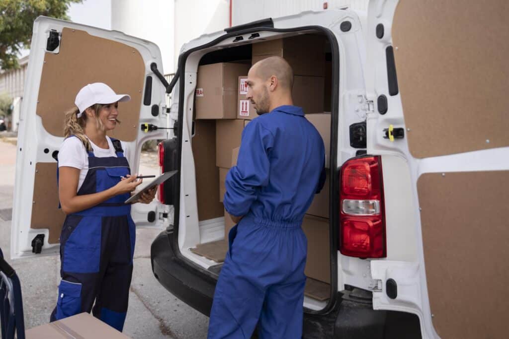 Man and van crew at the back of a white van full of boxes in the concept of 'What are man and van services for your move to Lewisham'.