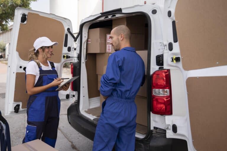 Man and van crew at the back of a white van full of boxes in the concept of 'What are man and van services for your move to Lewisham'.